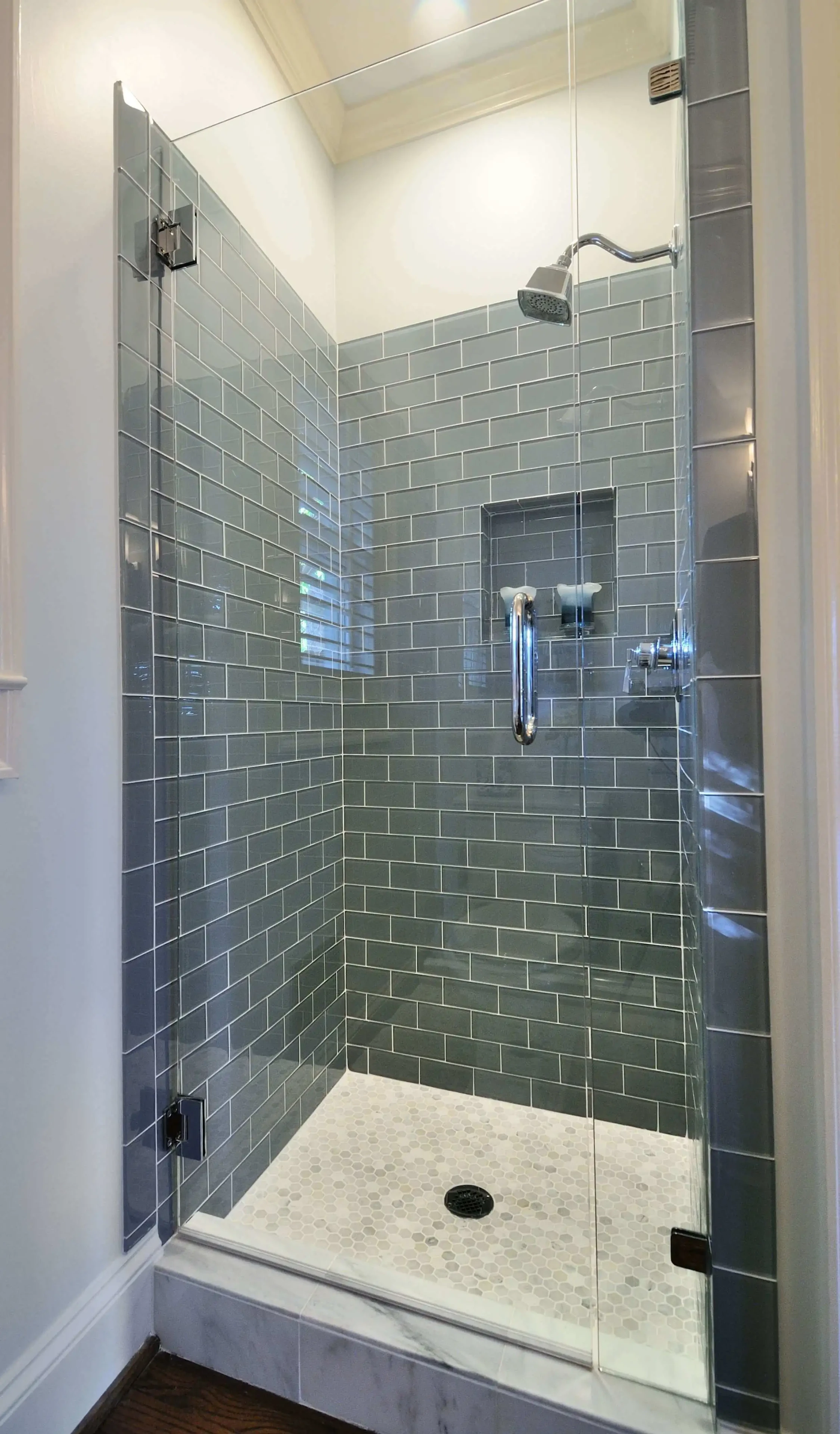 Modern bathroom shower with green subway tile