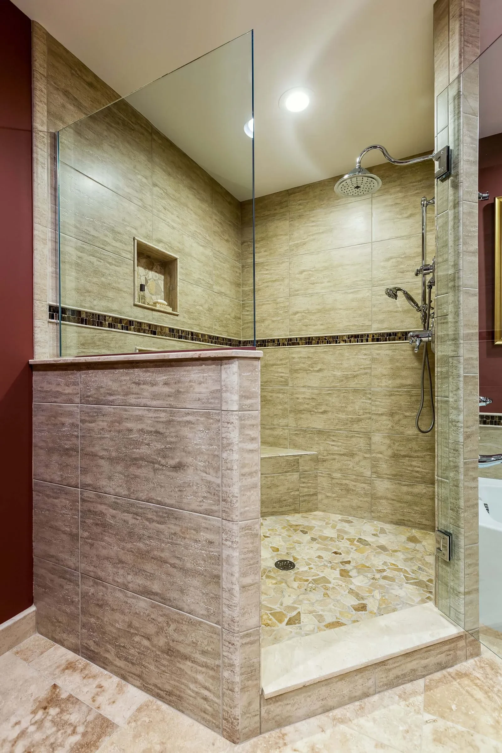 Travertine tile shower with rain head and glass enclosure