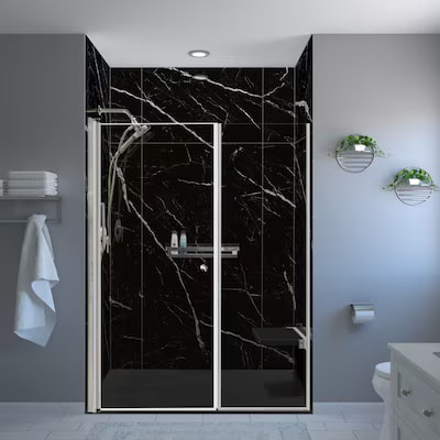 Black marble shower enclosure with chrome fixtures